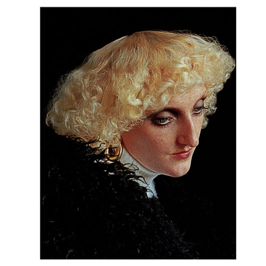 A framed artwork featuring a portrait of a person with curly blonde hair, predominantly in shades of black and white.